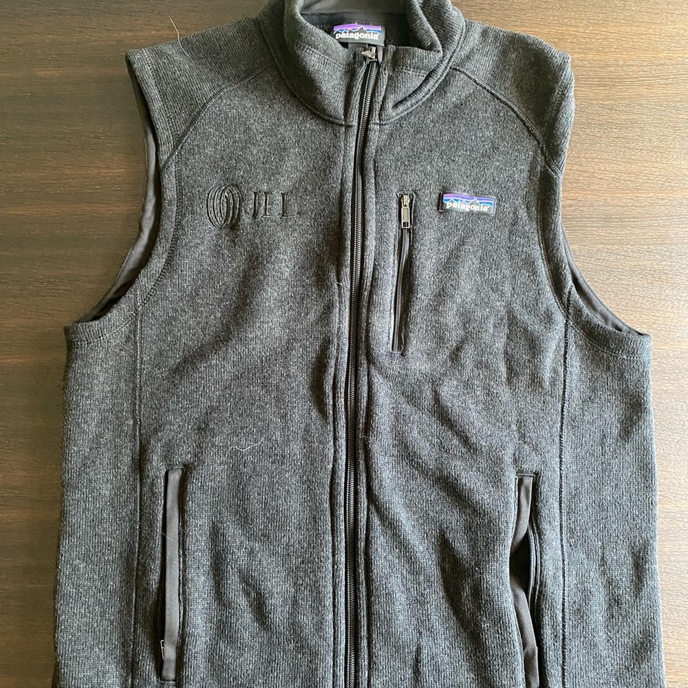 Gray Patagonia vest, medium. Like new. Embroidered with company logo.
